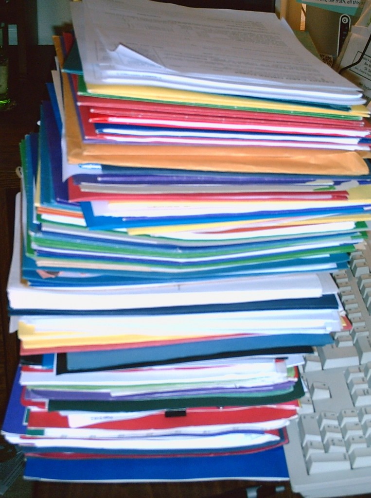 Stack of papers - busy is not a synonym for productive